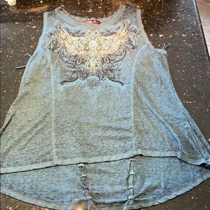 Cute top with studs and fringe on back.